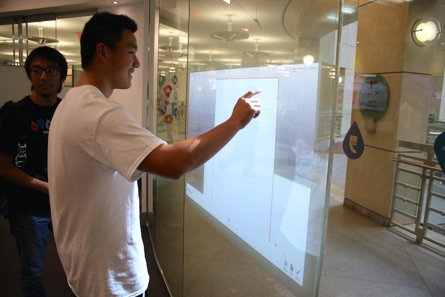 BYA member Robert Shi draws on an interactive wall.